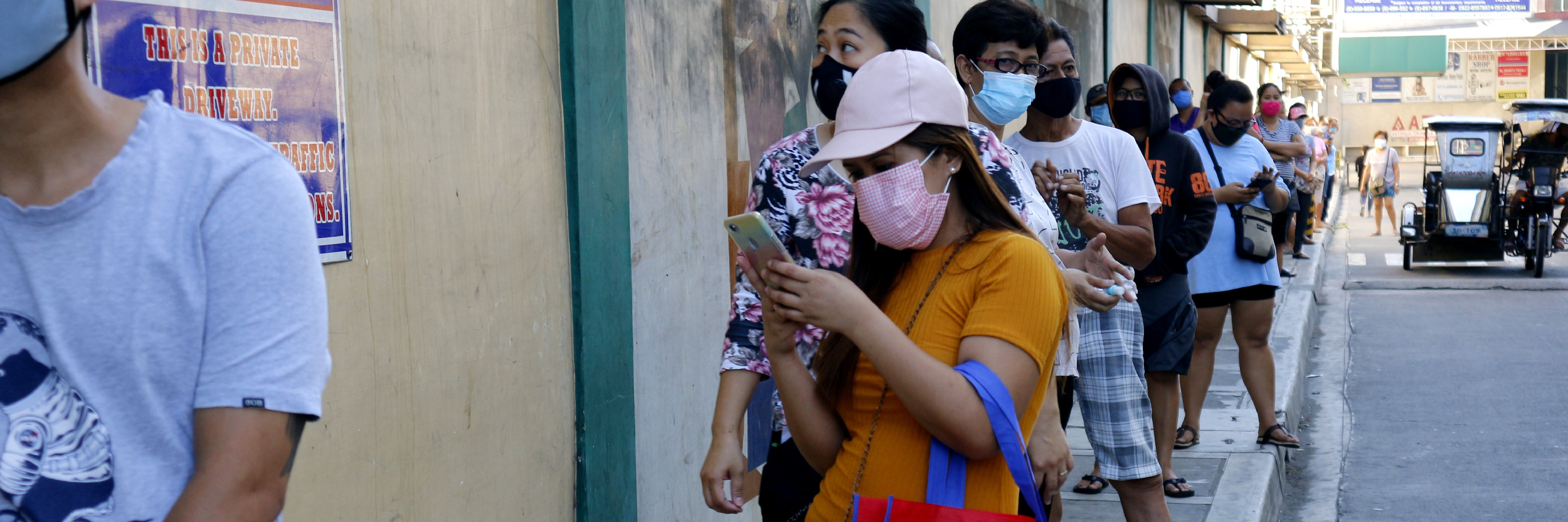 Customers line up outside a grocery store with distance from each other for social distancing during the Corona or Covid 19 virus outbreak